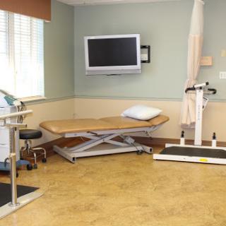 A clean and organized treatment room equipped for physical therapy.