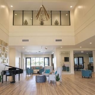 Spacious and modern lobby with elegant decor and a grand piano.