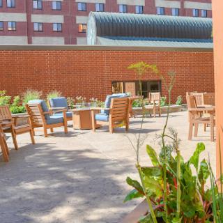 A cozy outdoor seating area surrounded by greenery, perfect for relaxation.
