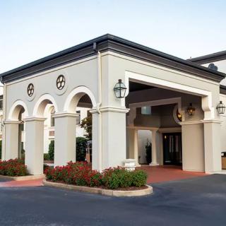 An elegant hotel entrance with classic architectural features and well-maintained landscaping.