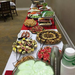 A buffet table with a variety of desserts and sweets arranged for an event.