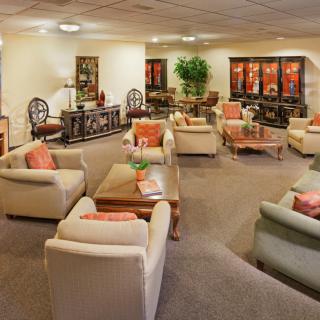 A spacious and elegantly decorated lounge area with comfortable seating and warm lighting.