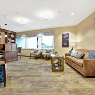 A modern living room with comfortable seating, wooden flooring, and tasteful decor.