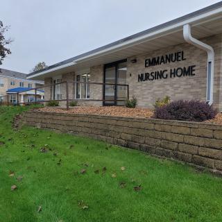 Exterior view of the Emanuel Nursing Home with landscaped surroundings.
