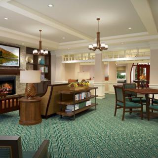 A spacious, elegantly designed living room featuring a fireplace and dining area.