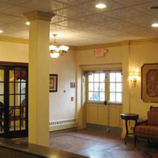 A cozy lobby area with warm lighting and comfortable seating.