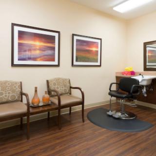A well-decorated waiting room with cozy seating and scenic artwork on the walls.
