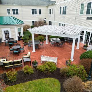 A view of a courtyard with outdoor seating and a pergola.