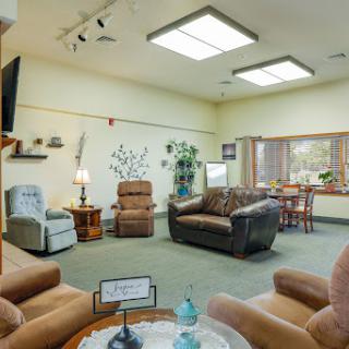 A cozy living room featuring comfortable seating and ample natural light, perfect for relaxation.