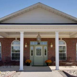 A building entrance with brick facade and columns.
