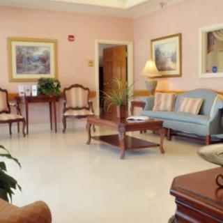 A cozy waiting room with classic furniture and soft lighting.