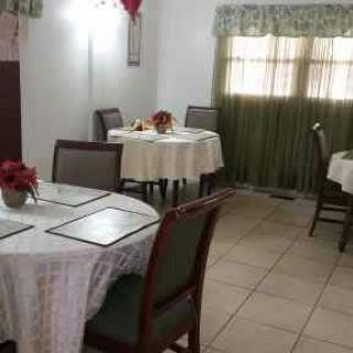 A cozy restaurant dining area with round tables covered in white tablecloths.
