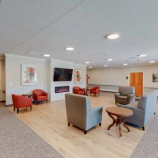 A modern lobby with comfortable seating and a television.