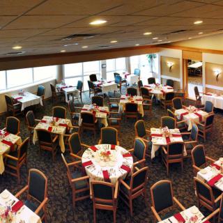 An elegant dining area with tables set for an event.