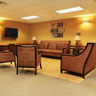 Comfortable seating area with a sofa, chairs, and a television.