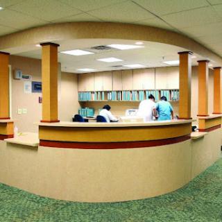 A view of a hospital reception area with medical staff attending to patients.