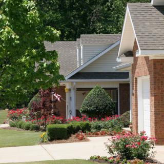 Suburban homes with well-maintained gardens and driveways.