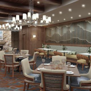 A modern and cozy restaurant dining room with elegant chandeliers and well-arranged tables and chairs.