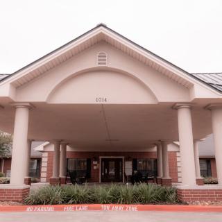 Front view of a building with a columned entrance.