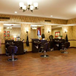 A well-lit and stylish hair salon featuring modern barber chairs and elegant decor.