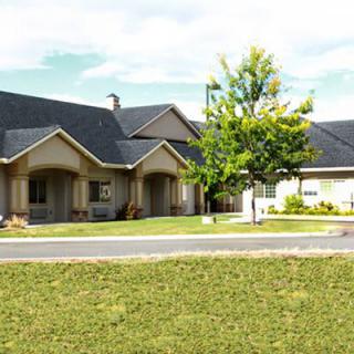 A suburban house with a well-maintained lawn and driveway.