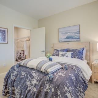 A cozy bedroom interior with a neatly made bed and calming decor.