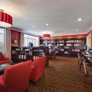 A cozy library interior with bookshelves and comfortable seating.