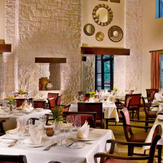 A beautifully decorated restaurant interior with elegantly set tables, ready for fine dining.