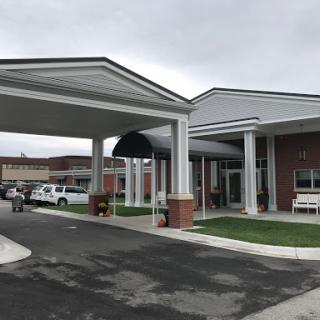 The entrance of a healthcare facility featuring a covered walkway.