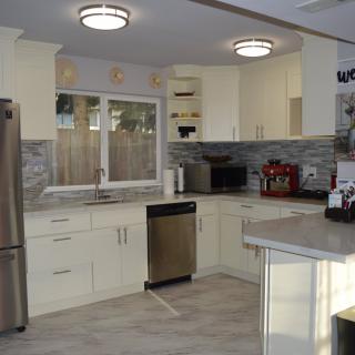 Modern kitchen with stainless steel appliances and sleek cabinetry.