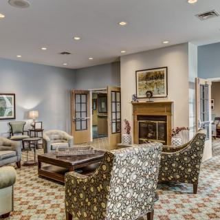 A cozy living room with elegant furniture, a fireplace, and stylish decor.