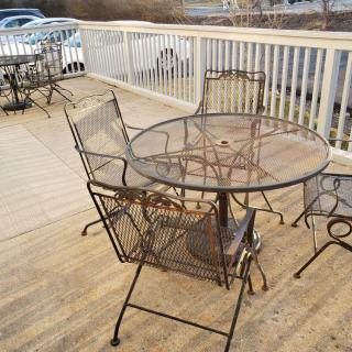 Outdoor metal patio furniture on a wooden deck