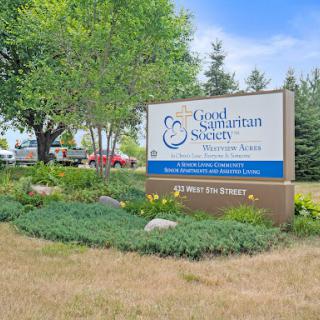 The entrance sign of the Good Samaritan Society, surrounded by well-maintained landscaping.