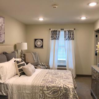 A cozy bedroom with neutral decor and elegant furnishings.