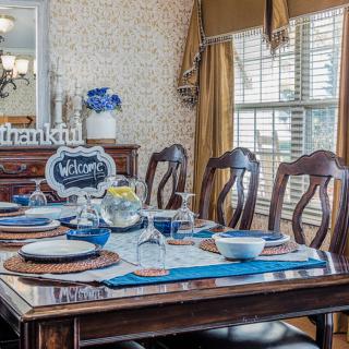 A beautifully set dining table with blue accents and a welcoming atmosphere.