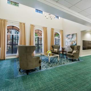 A cozy lobby area with comfortable seating and large windows.