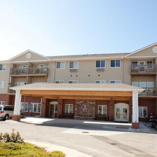 A view of a modern residential building featuring balconies and an inviting entrance.