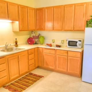 A cozy kitchen with wooden cabinets and modern appliances.