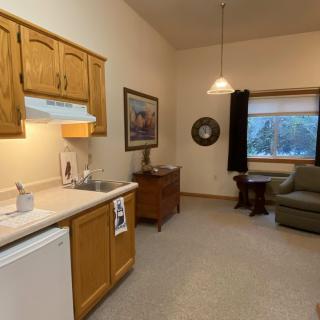 A cozy interior featuring a small kitchen and comfortable living area.