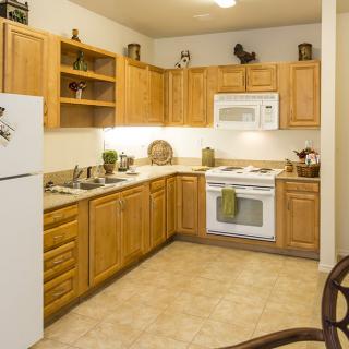 A cozy kitchen with wooden cabinets and modern appliances.