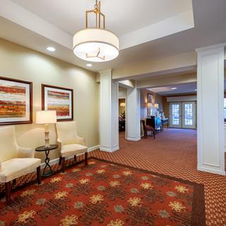 A spacious lobby area with seating, artwork, and elegant lighting.