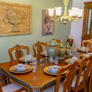 A beautifully set dining room with elegant furniture and decor.