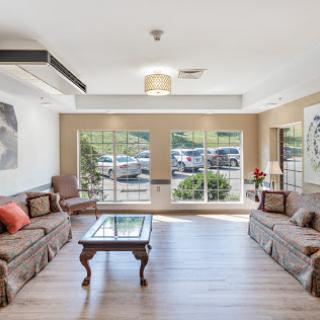 A beautifully designed living room featuring comfortable seating and ample natural light.