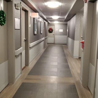 A well-lit hallway with decorative elements and a mix of flooring styles.