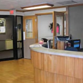 A reception area with a curved desk and seating in an office or business setting.