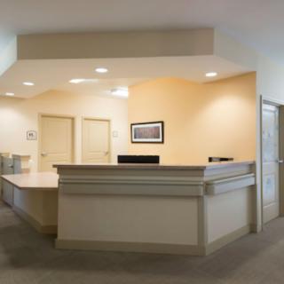 A modern reception desk in an office lobby.