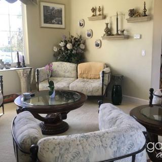 A cozy living room with vintage furniture and elegant decor.