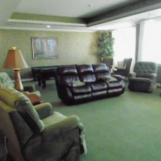 A cozy living room with comfortable seating and soft lighting.