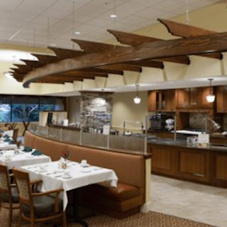 A cozy restaurant interior with wooden ceiling decor and a comfortable dining area.