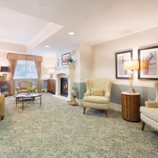 A cozy and elegantly furnished living room featuring comfortable seating, a fireplace, and tasteful decor.
